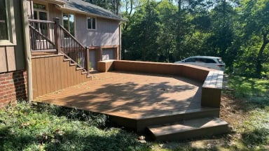 Modern wooden deck with steps and landscaping