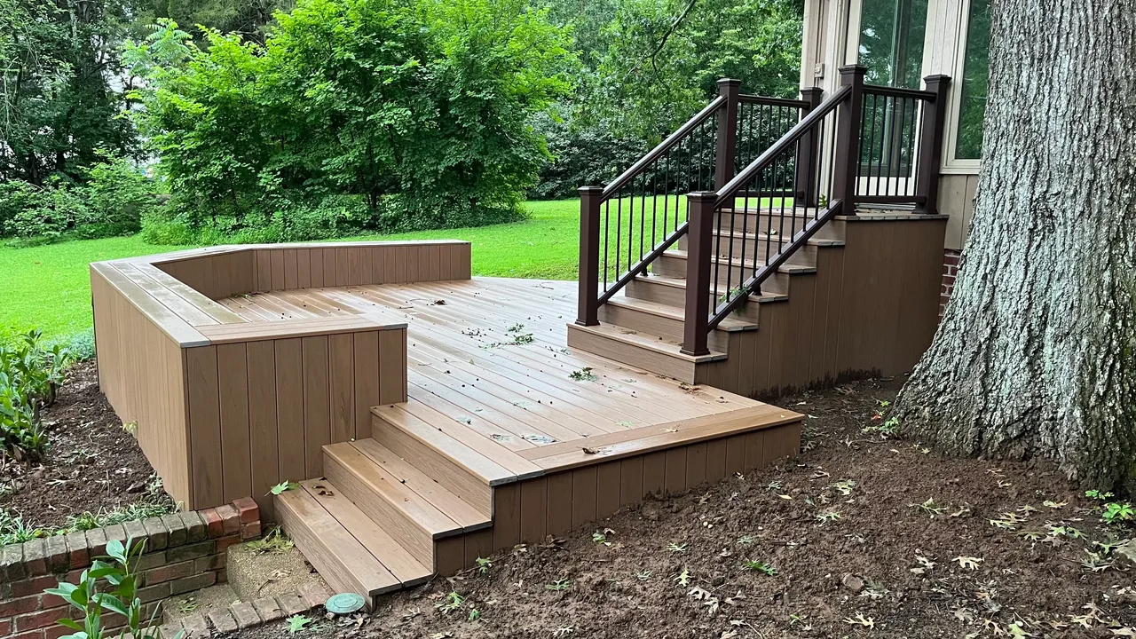 Newly constructed wooden deck with stairs in a garden.